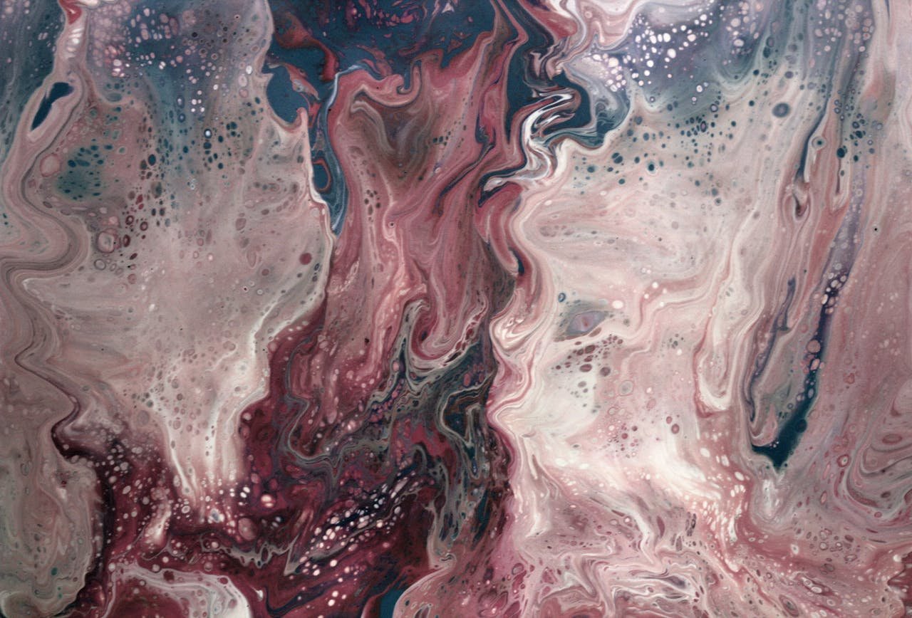 A vibrant abstract fluid painting with swirling pink, white, and blue hues.